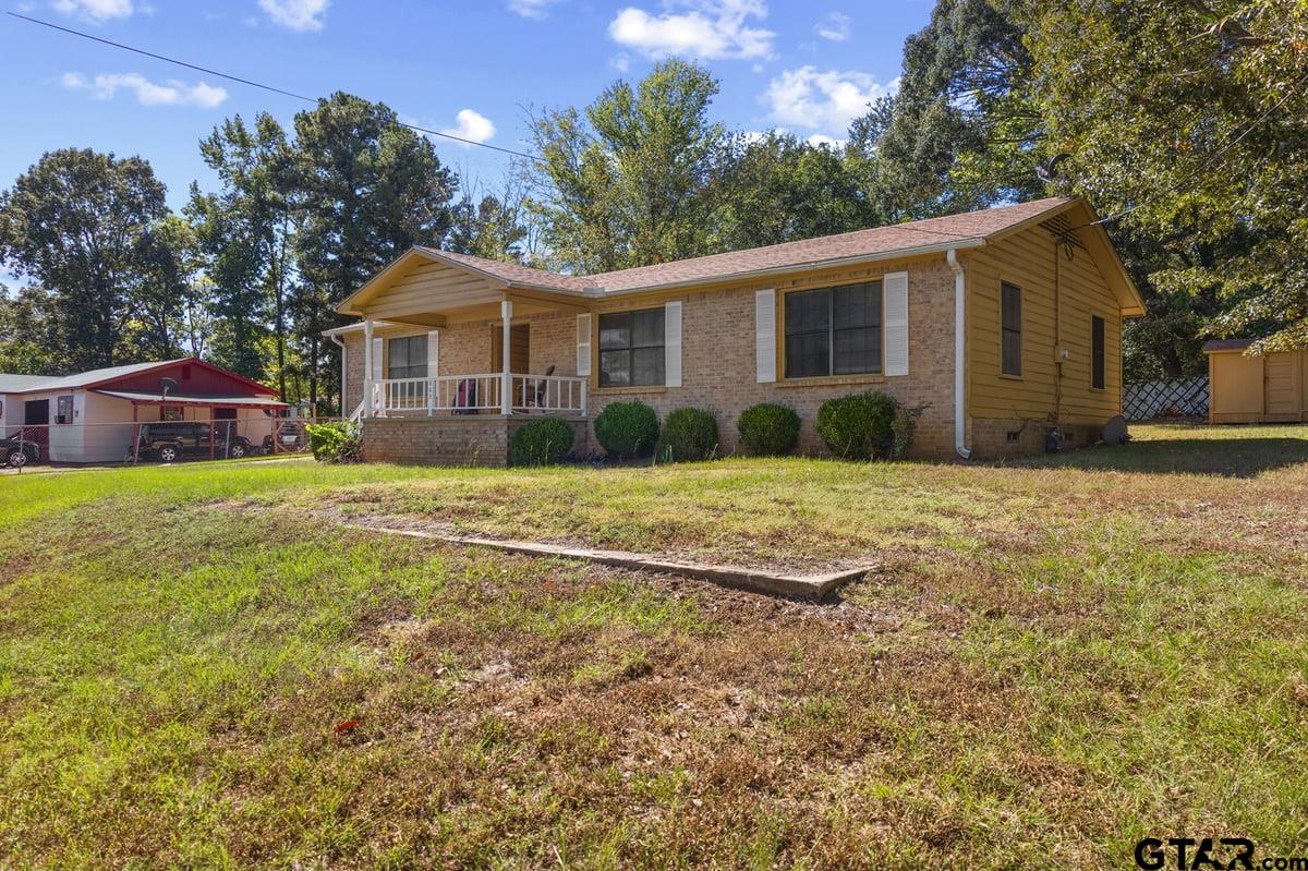 807 High Street Marshall, TX 75670 - Photo 4 of 33 a view of a yard in front of a house with large tree