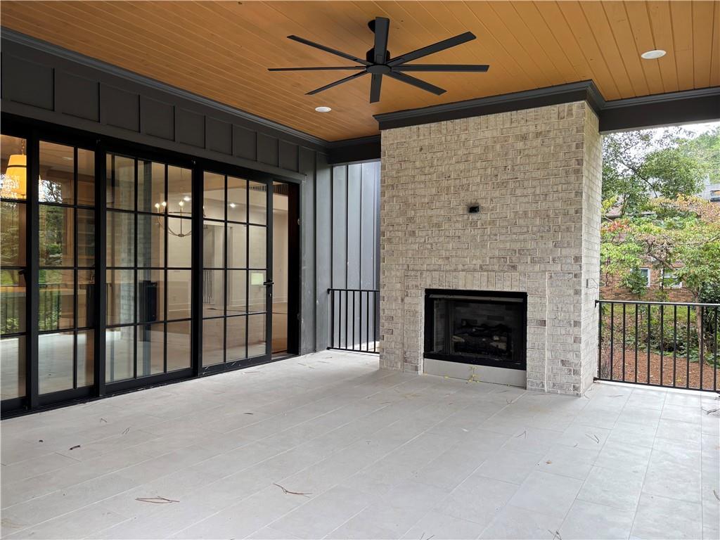 180 Thompson Place Roswell, GA 30075 - Photo 12 of 12 a view of a livingroom with a fireplace and a ceiling fan
