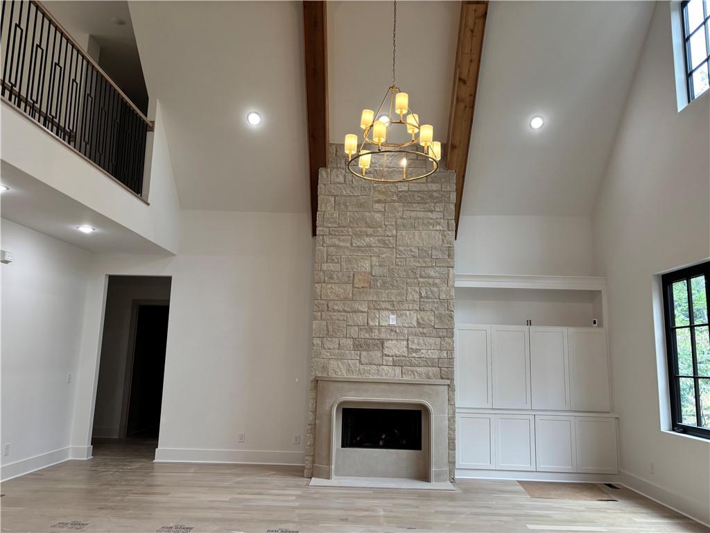 180 Thompson Place Roswell, GA 30075 - Photo 5 of 12 a room with a fireplace and chandelier
