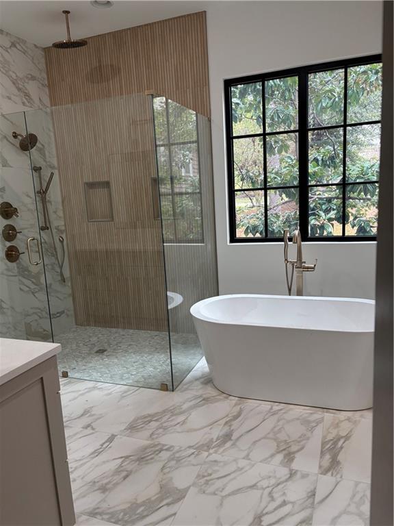 180 Thompson Place Roswell, GA 30075 - Photo 8 of 12 a bathroom with a bathtub and window