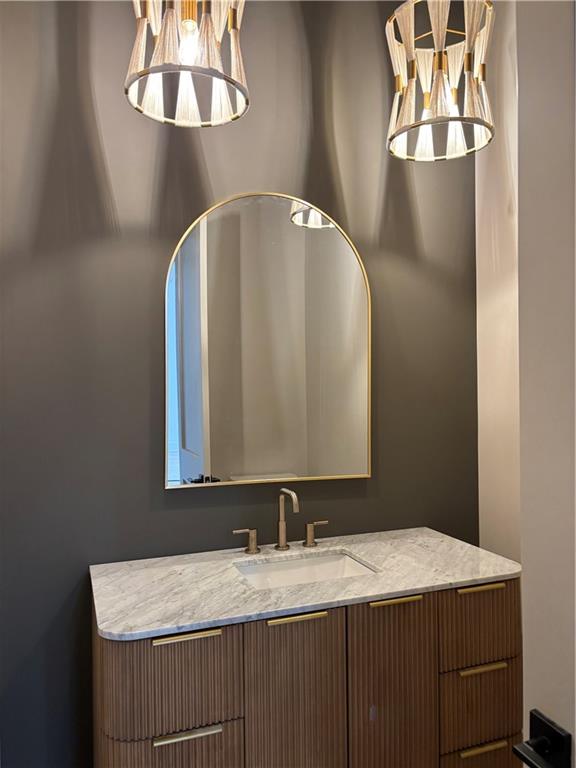 180 Thompson Place Roswell, GA 30075 - Photo 9 of 12 a bathroom with a granite countertop sink and a mirror
