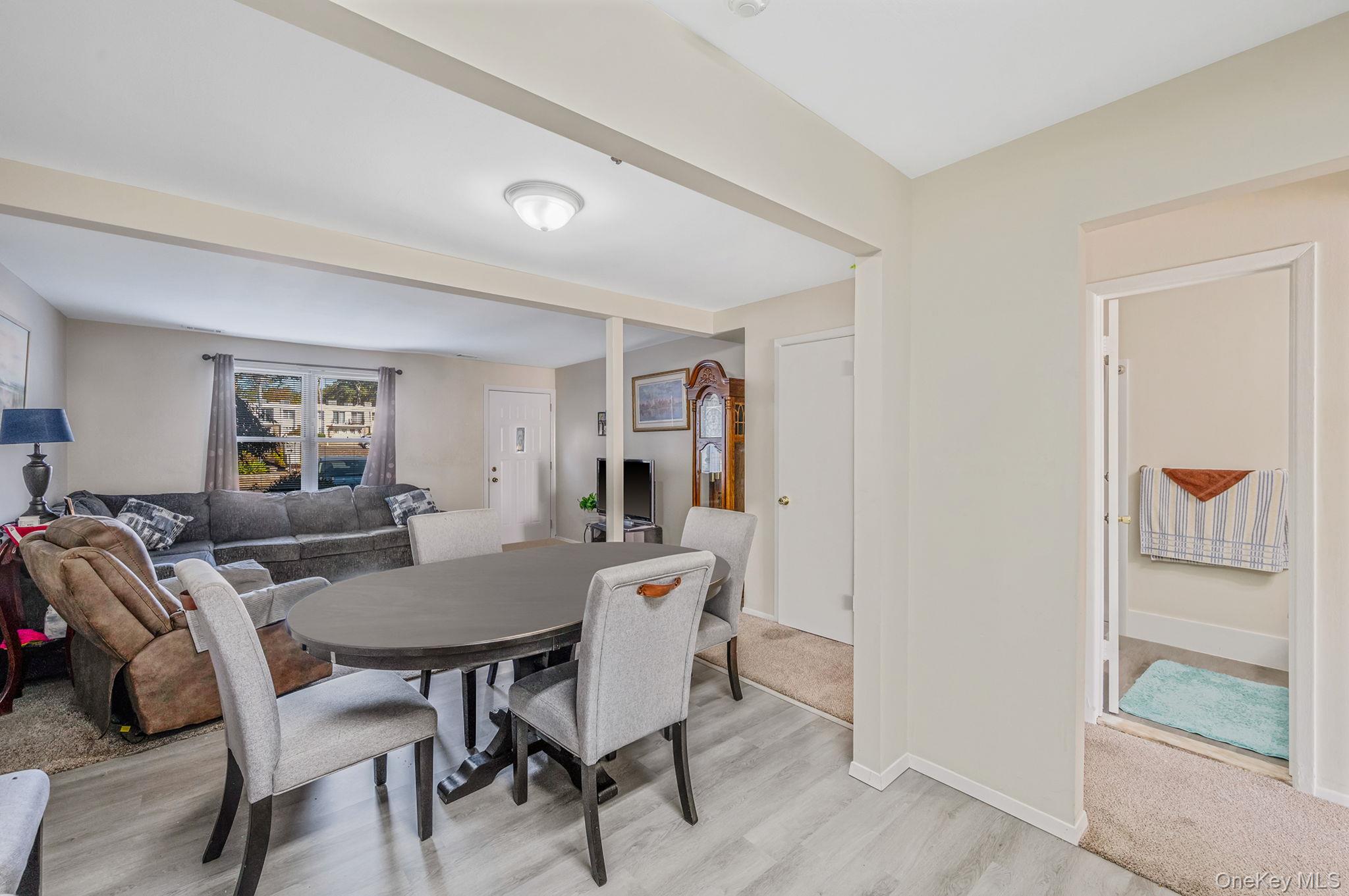 63 Rocky Point Yaphank Road, Unit 80 Rocky Point, NY 11778 - Photo 11 of 25 Dining room with light wood-type flooring and beamed ceiling