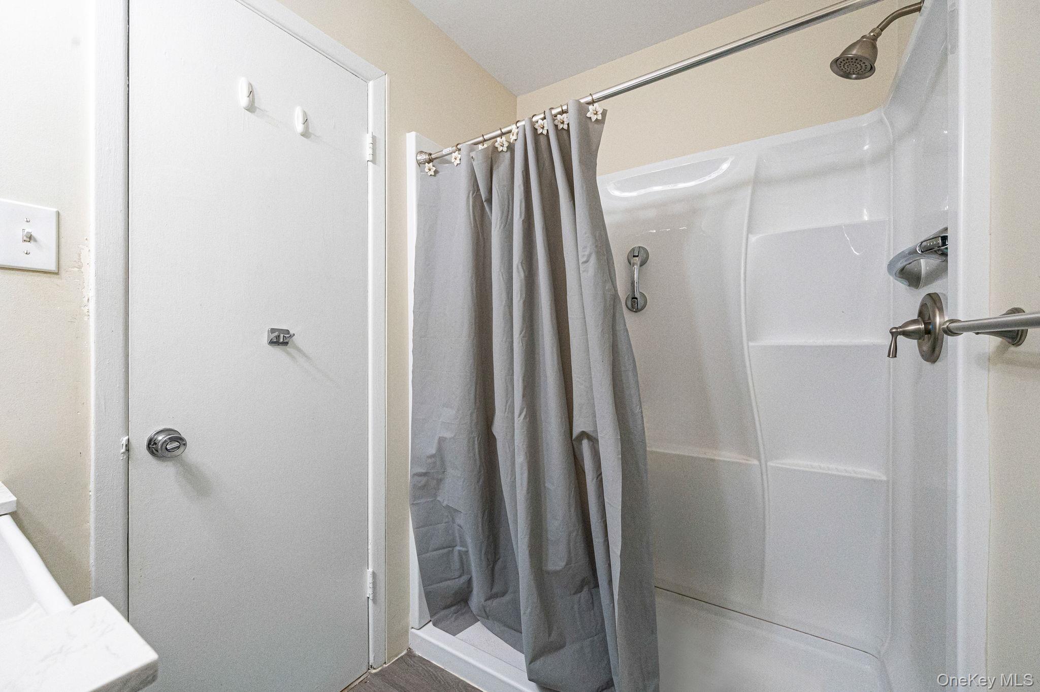 63 Rocky Point Yaphank Road, Unit 80 Rocky Point, NY 11778 - Photo 13 of 25 Full bath with a stall shower and vanity