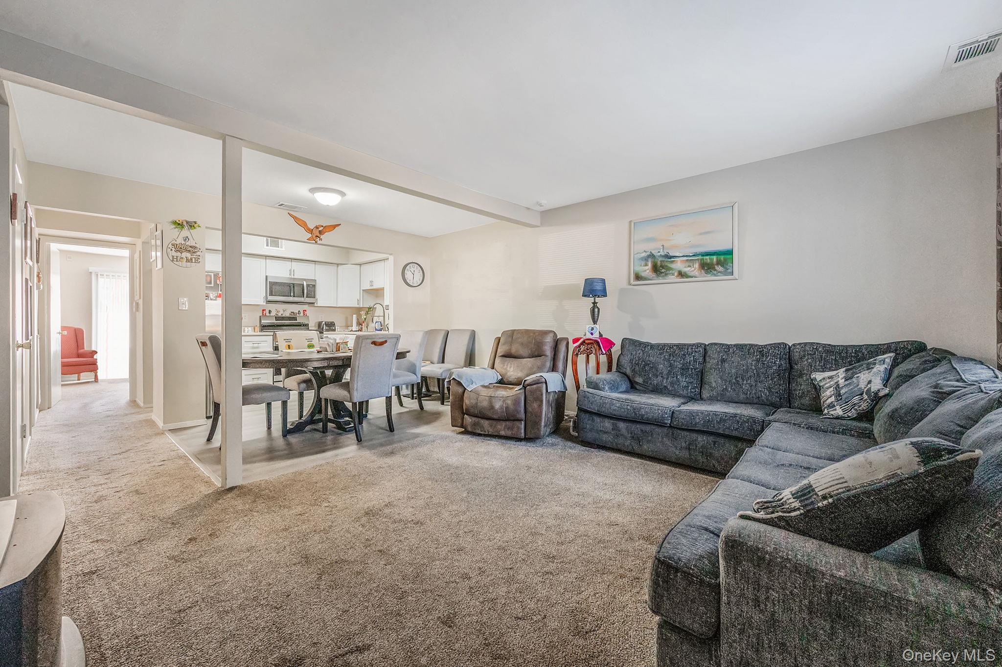 63 Rocky Point Yaphank Road, Unit 80 Rocky Point, NY 11778 - Photo 3 of 25 Living room with light carpet