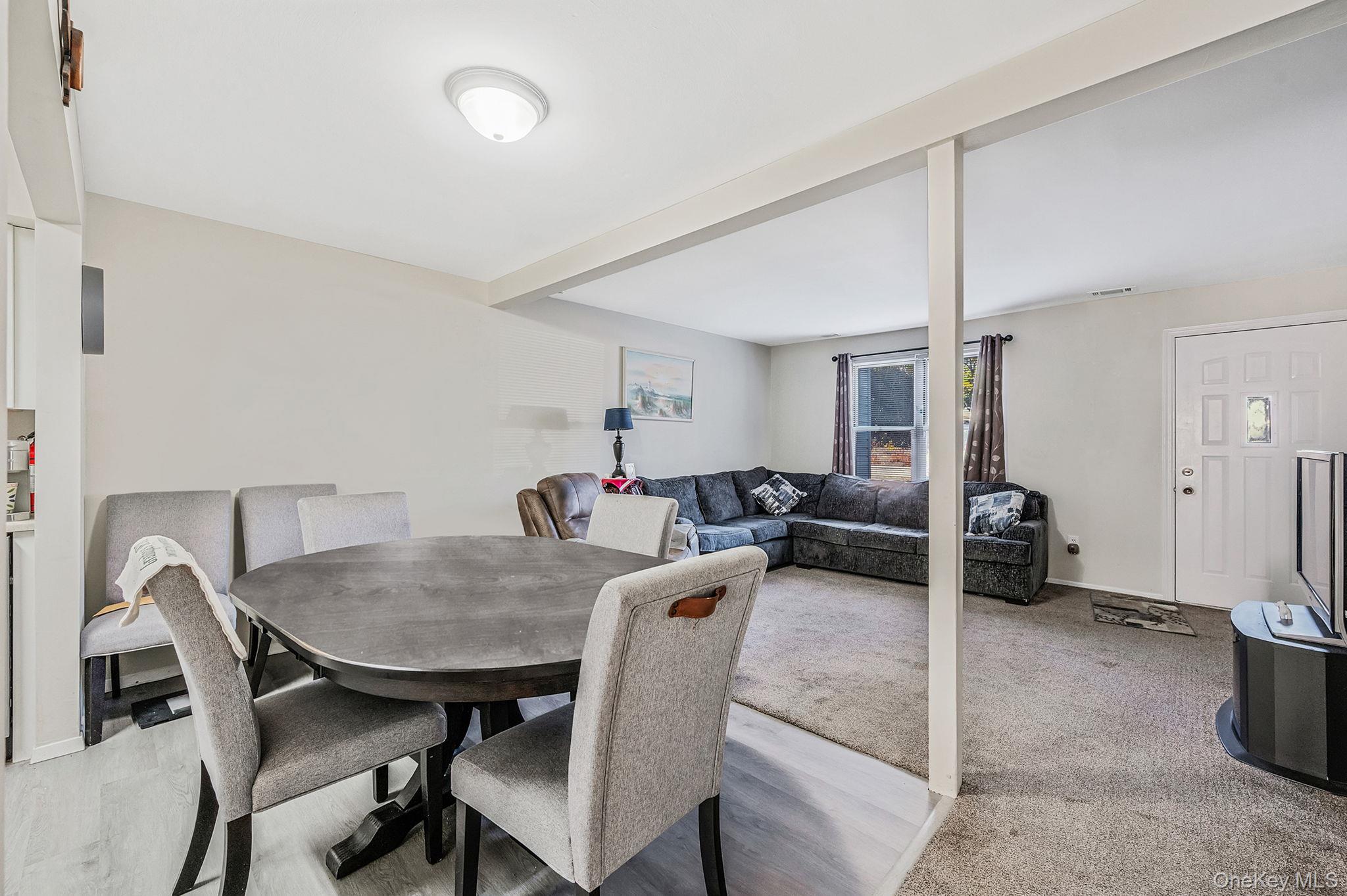 63 Rocky Point Yaphank Road, Unit 80 Rocky Point, NY 11778 - Photo 6 of 25 Dining area with baseboards and light colored carpet