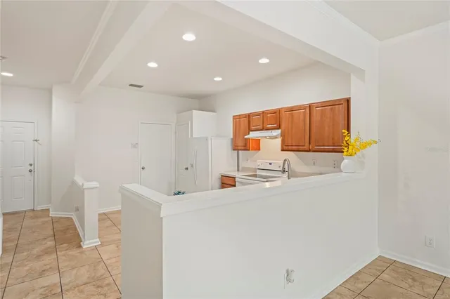 a view of a kitchen with a sink cabinetry and chandelier