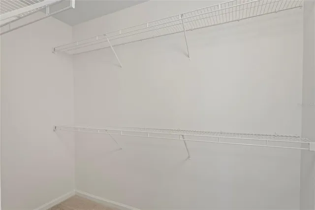 an empty room with a chandelier fan