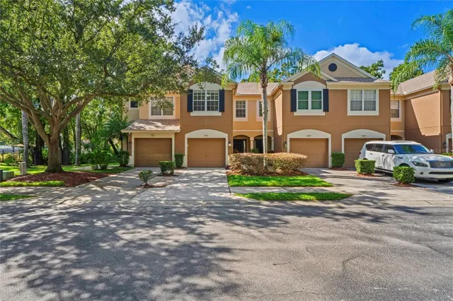 a front view of a house with cars parked