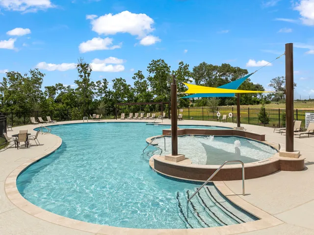 a view of a swimming pool with a patio and a yard