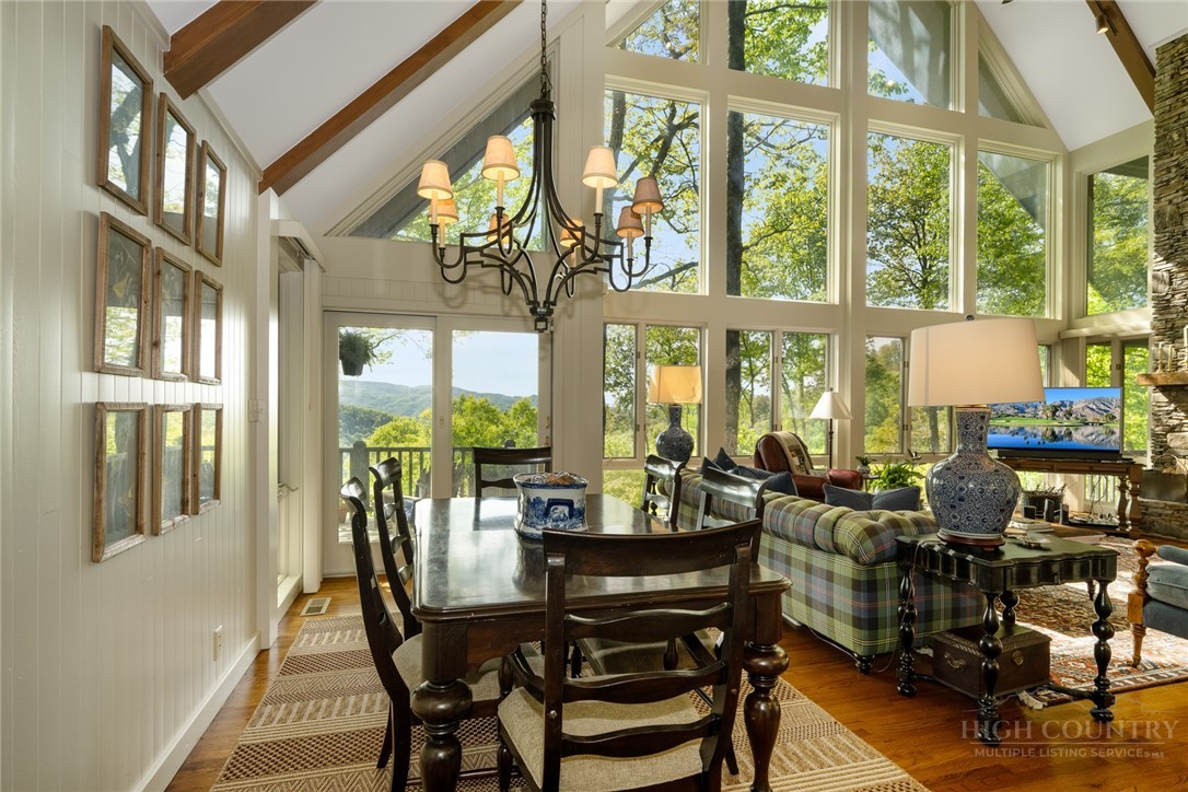 246 Mulberry Lane Boone, NC 28607 - Photo 7 of 49 a view of a dining room with furniture large windows and wooden floor