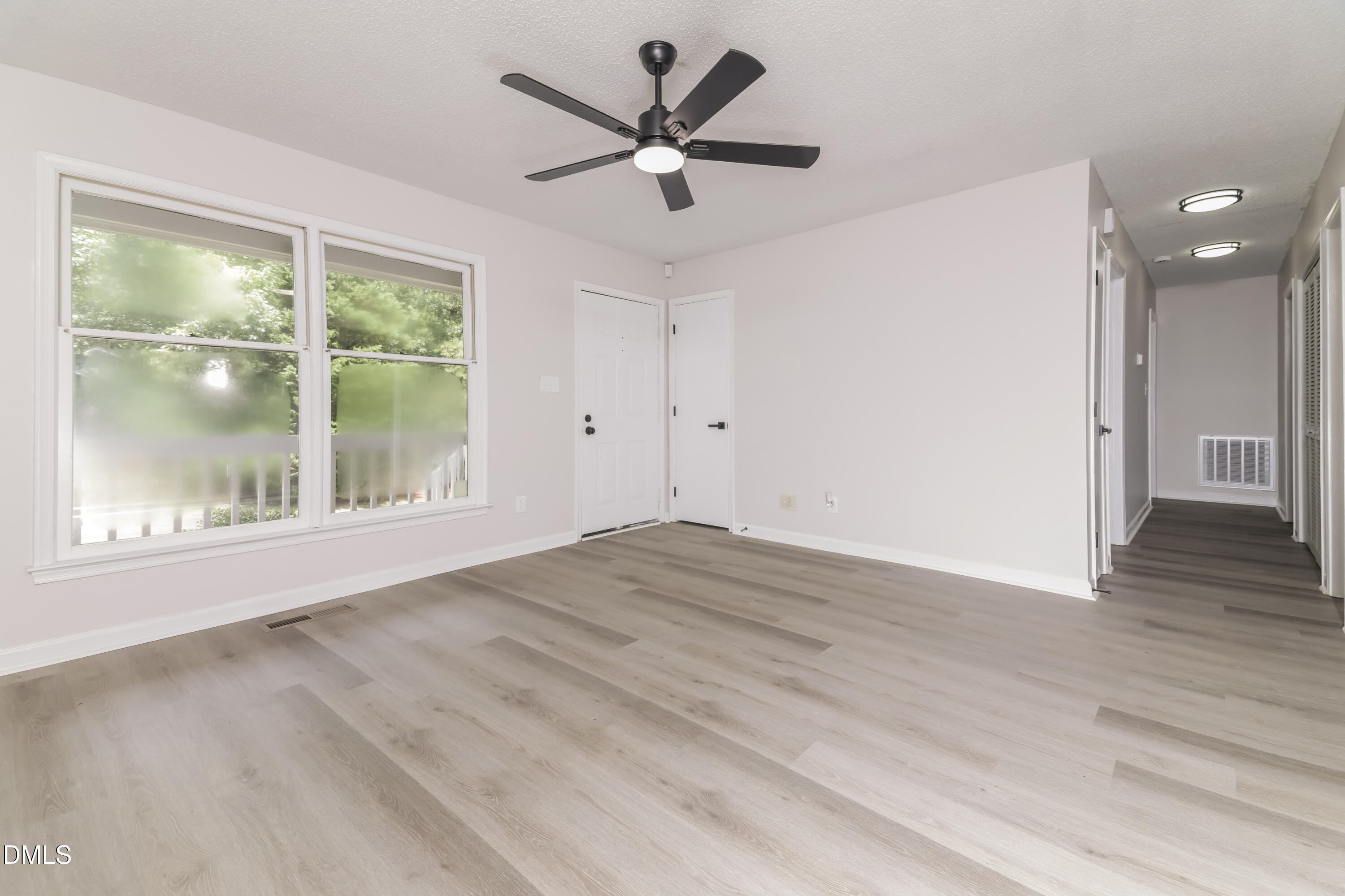 6 Fircrest Court Durham, NC 27703 - Photo 3 of 15 a view of empty room with wooden floor and fan