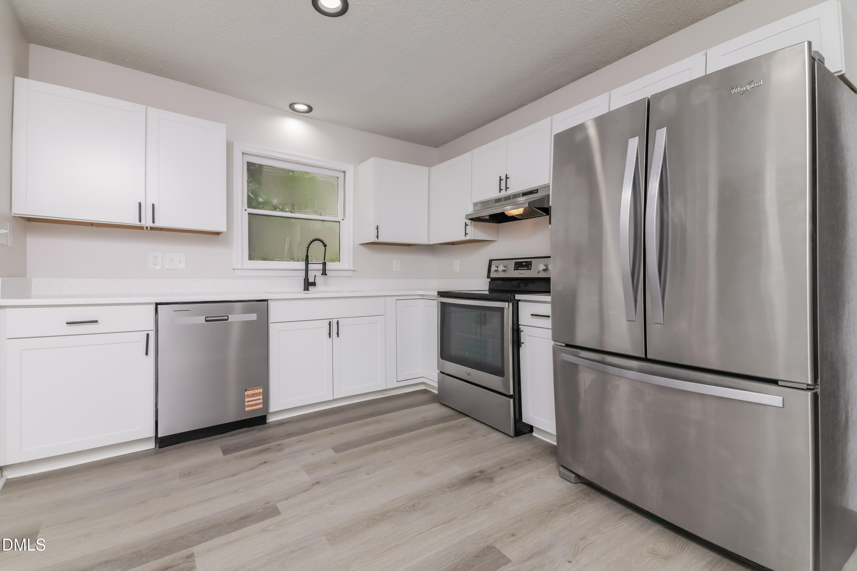 6 Fircrest Court Durham, NC 27703 - Photo 5 of 15 a kitchen with a refrigerator sink and cabinets