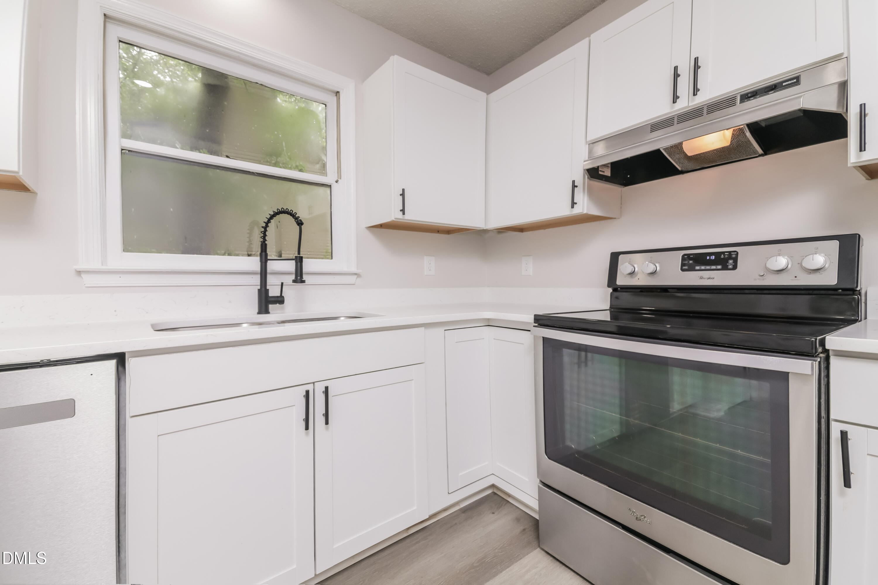 6 Fircrest Court Durham, NC 27703 - Photo 6 of 15 a kitchen with granite countertop white cabinets appliances and a sink