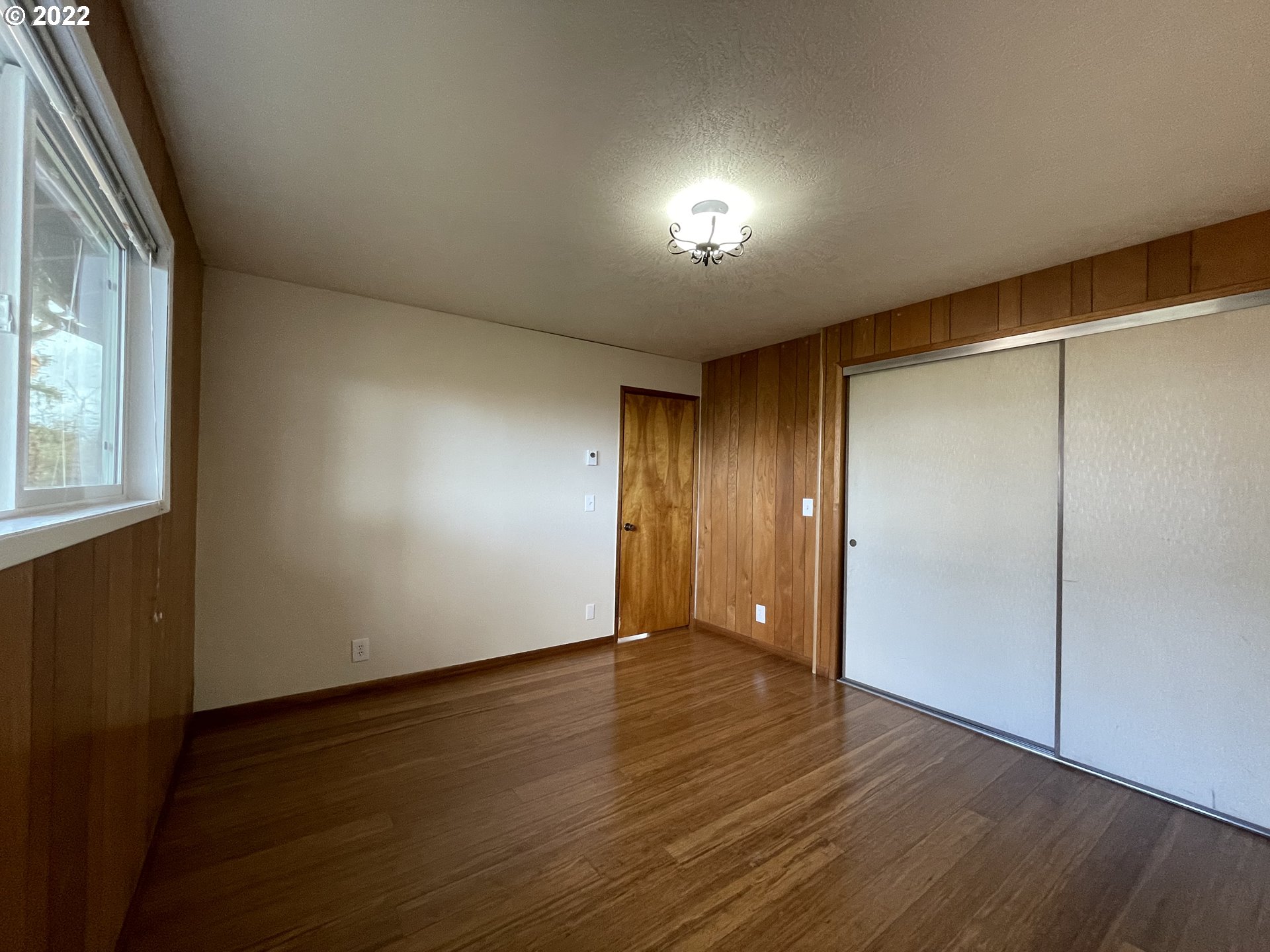 2901 Ingalls Way Eugene, OR 97405 - Photo 12 of 32 an empty room with wooden floor and windows