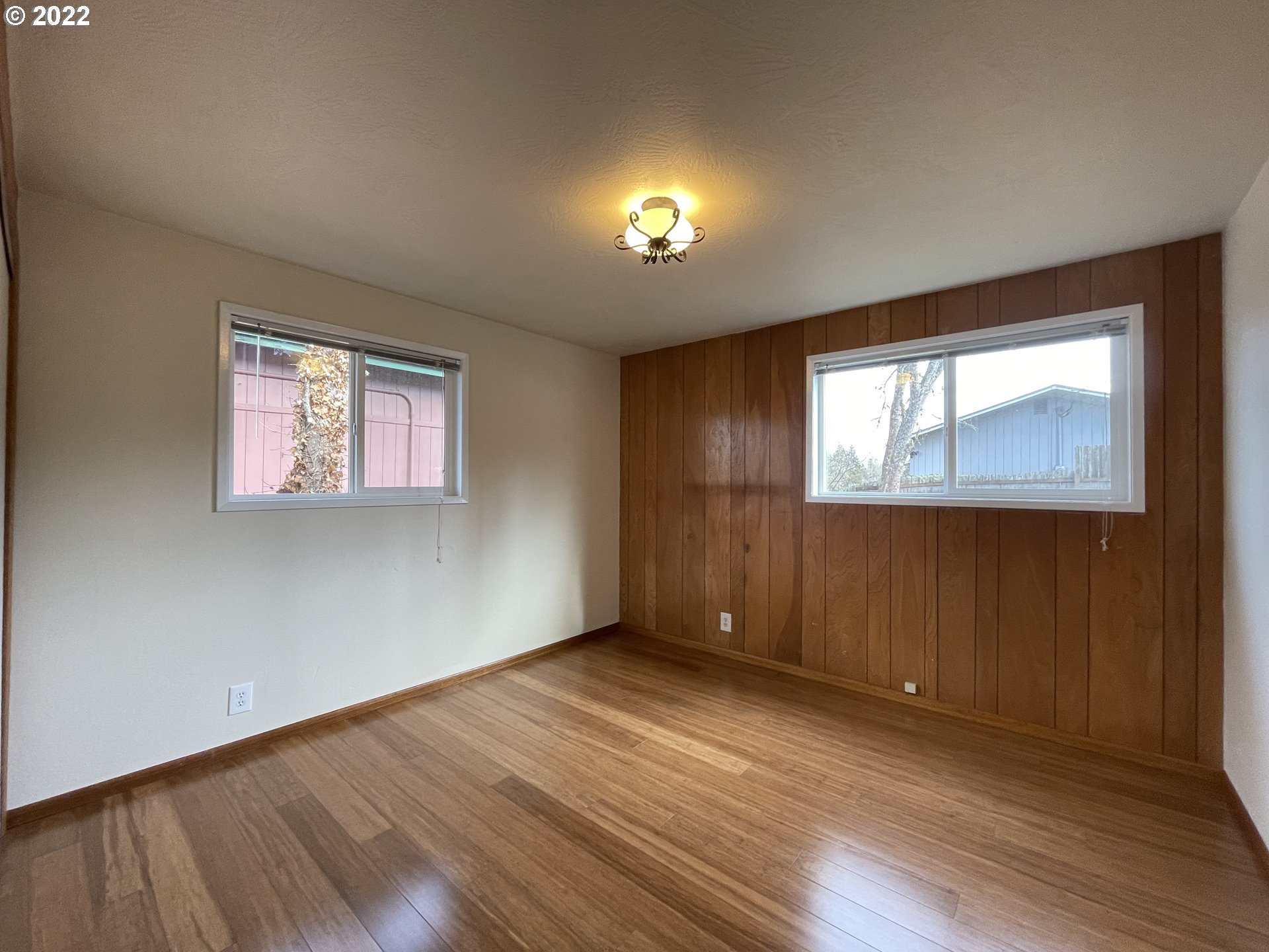 2901 Ingalls Way Eugene, OR 97405 - Photo 13 of 32 an empty room with wooden floor and windows