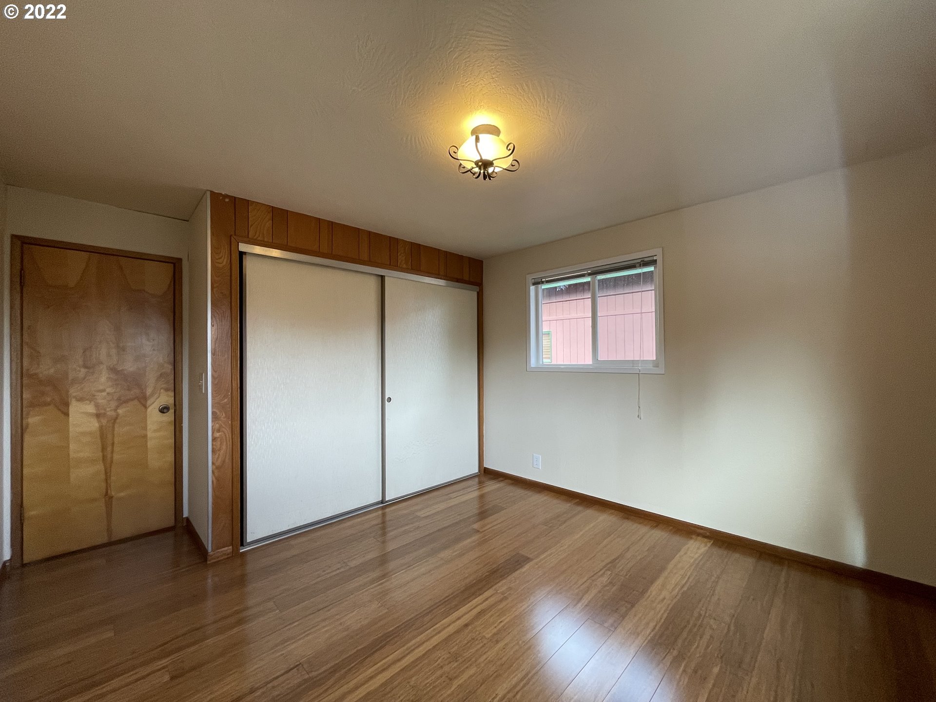 2901 Ingalls Way Eugene, OR 97405 - Photo 14 of 32 a view of an empty room with wooden floor and a window