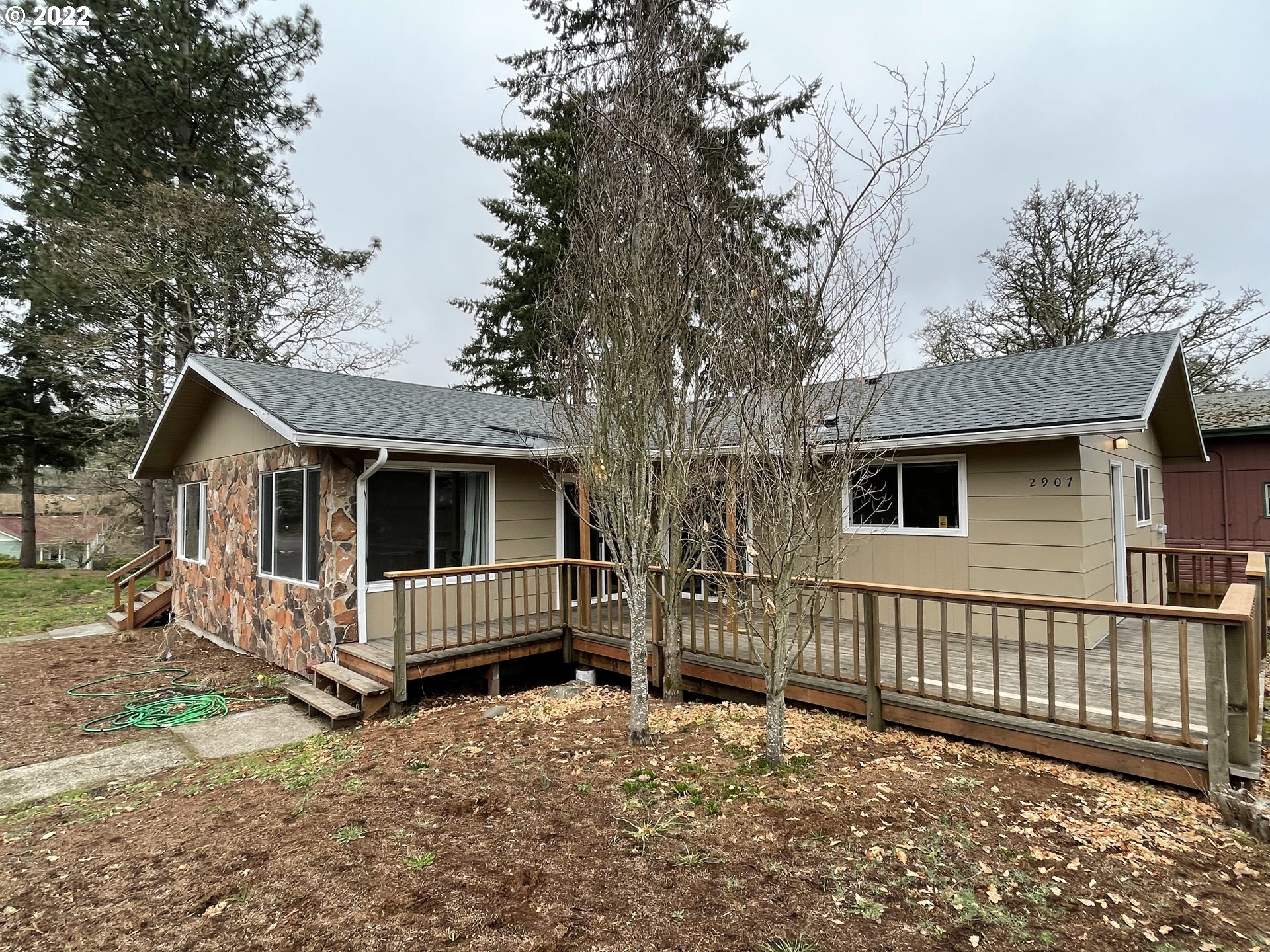 2901 Ingalls Way Eugene, OR 97405 - Photo 2 of 32 a view of a house with wooden fence and a trees