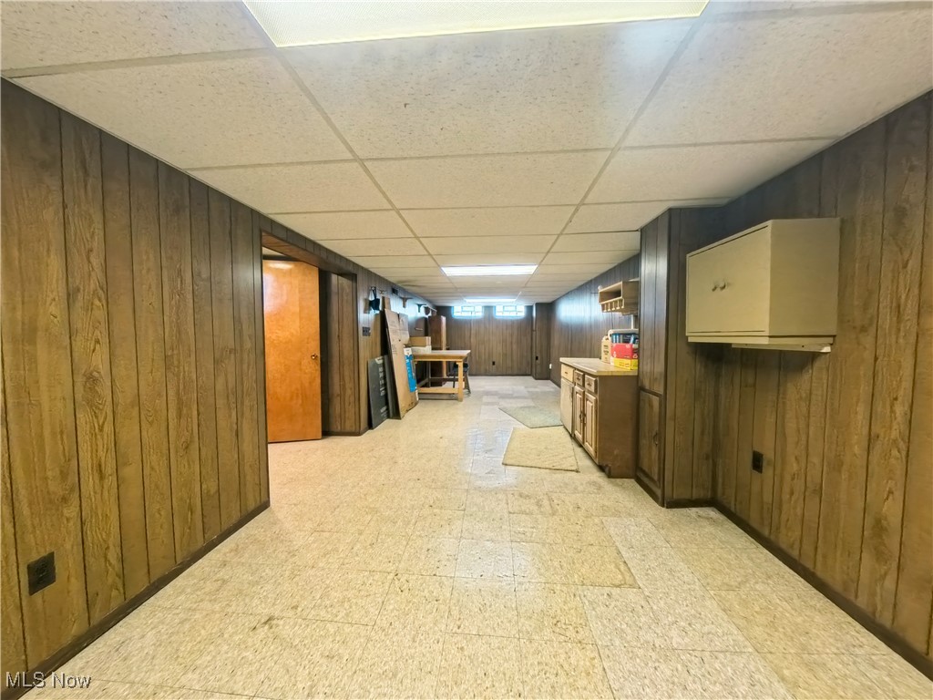 1668 Harwich Road Cleveland, OH 44124 - Photo 14 of 19 Basement featuring light flooring, wood walls, and a drop ceiling