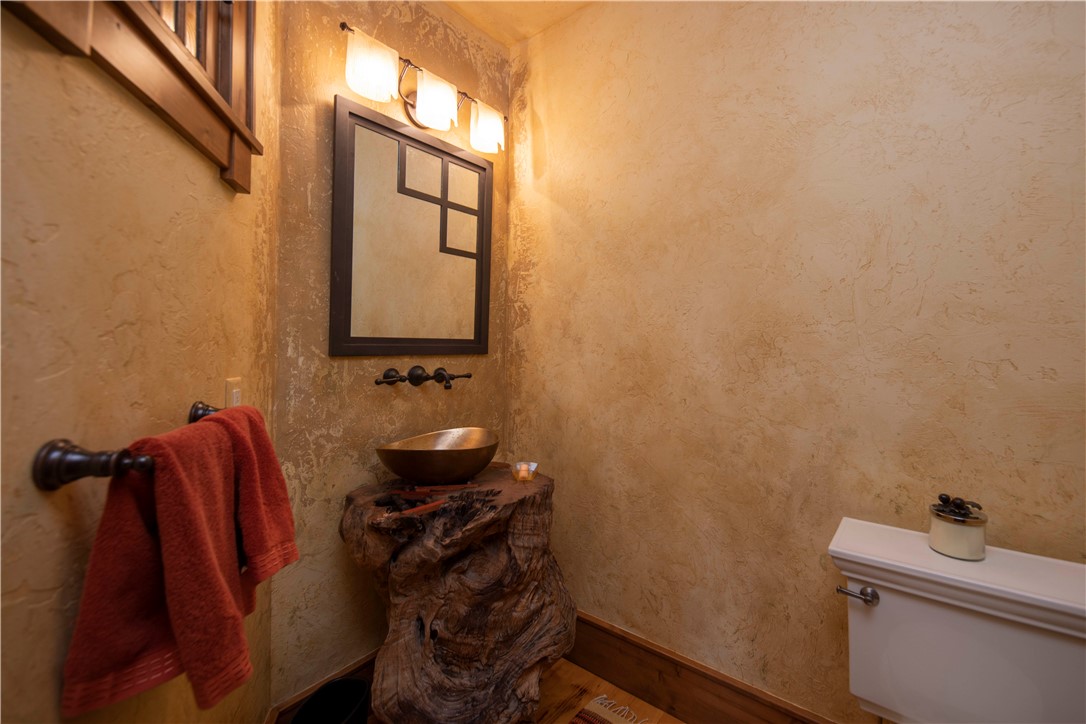 211 Highlands Drive Breckenridge, CO 80424 - Photo 29 of 35 The powder room features a petrified wood pedestal sink from Santa Fe.