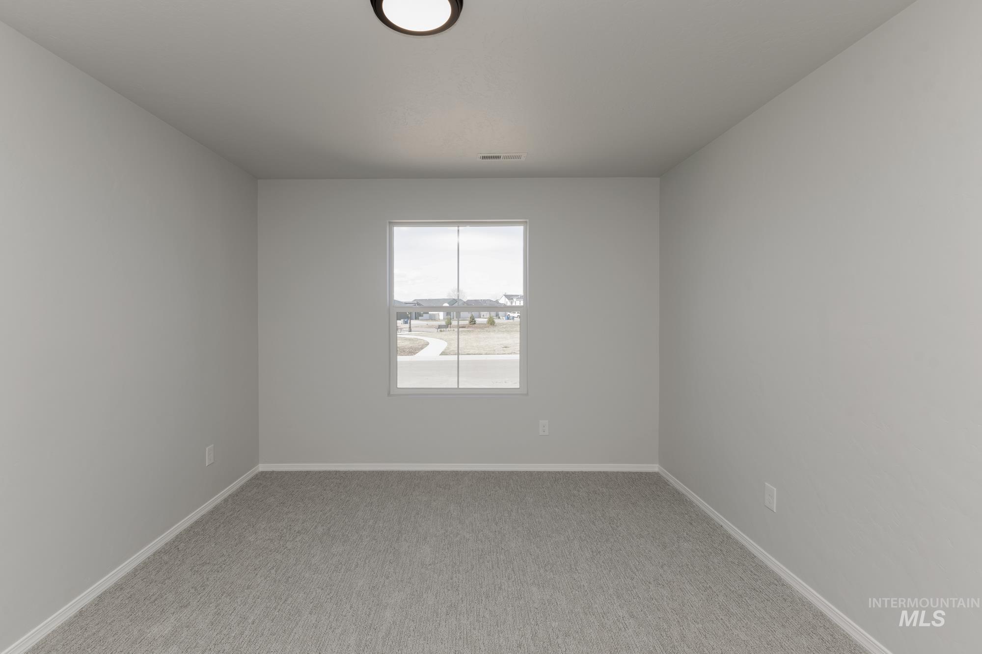 3270 South Maple Rnch Way Nampa, ID 83686 - Photo 16 of 31 Empty room featuring light colored carpet and baseboards