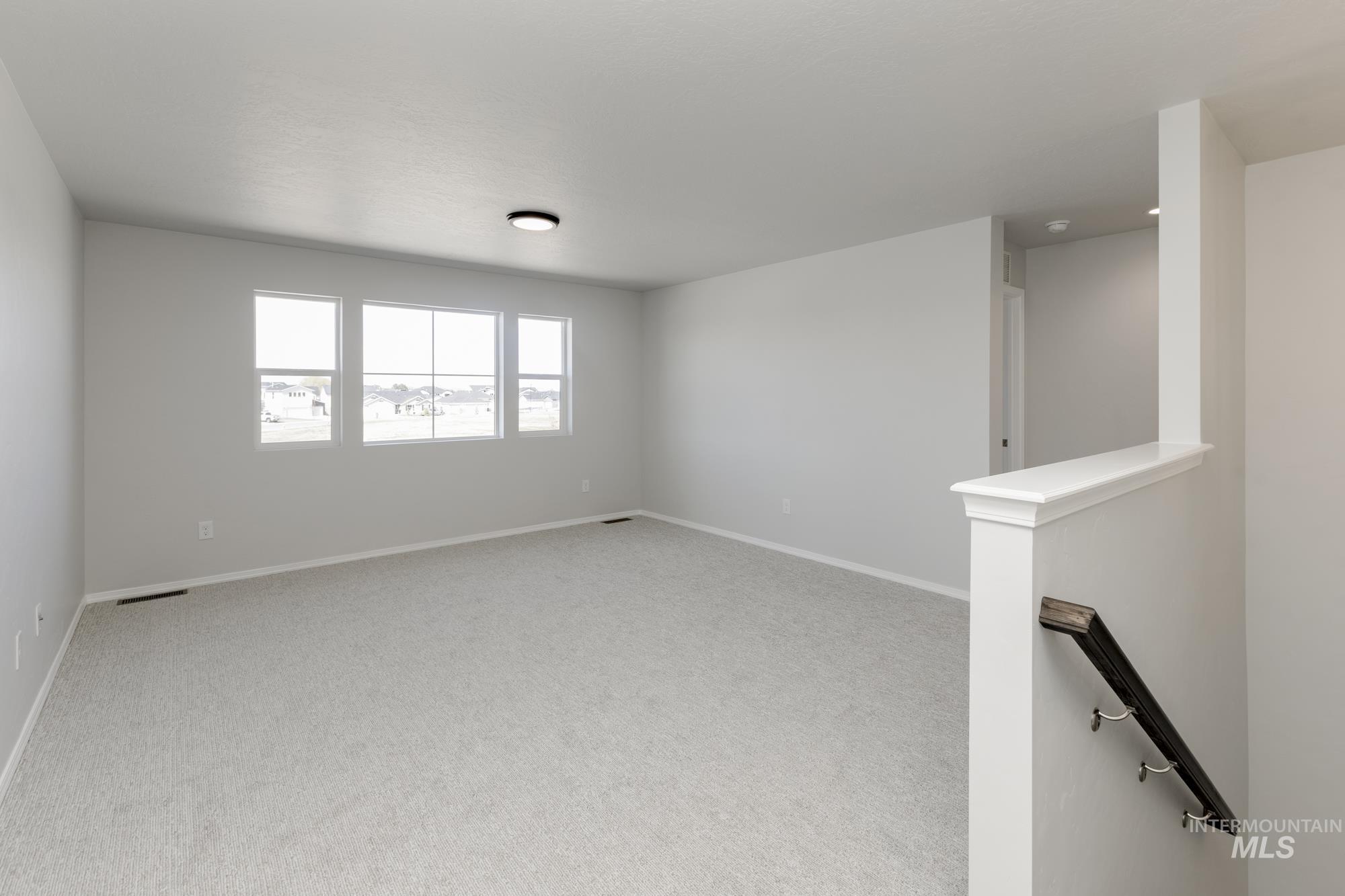 3270 South Maple Rnch Way Nampa, ID 83686 - Photo 18 of 31 Spare room featuring light carpet and baseboards