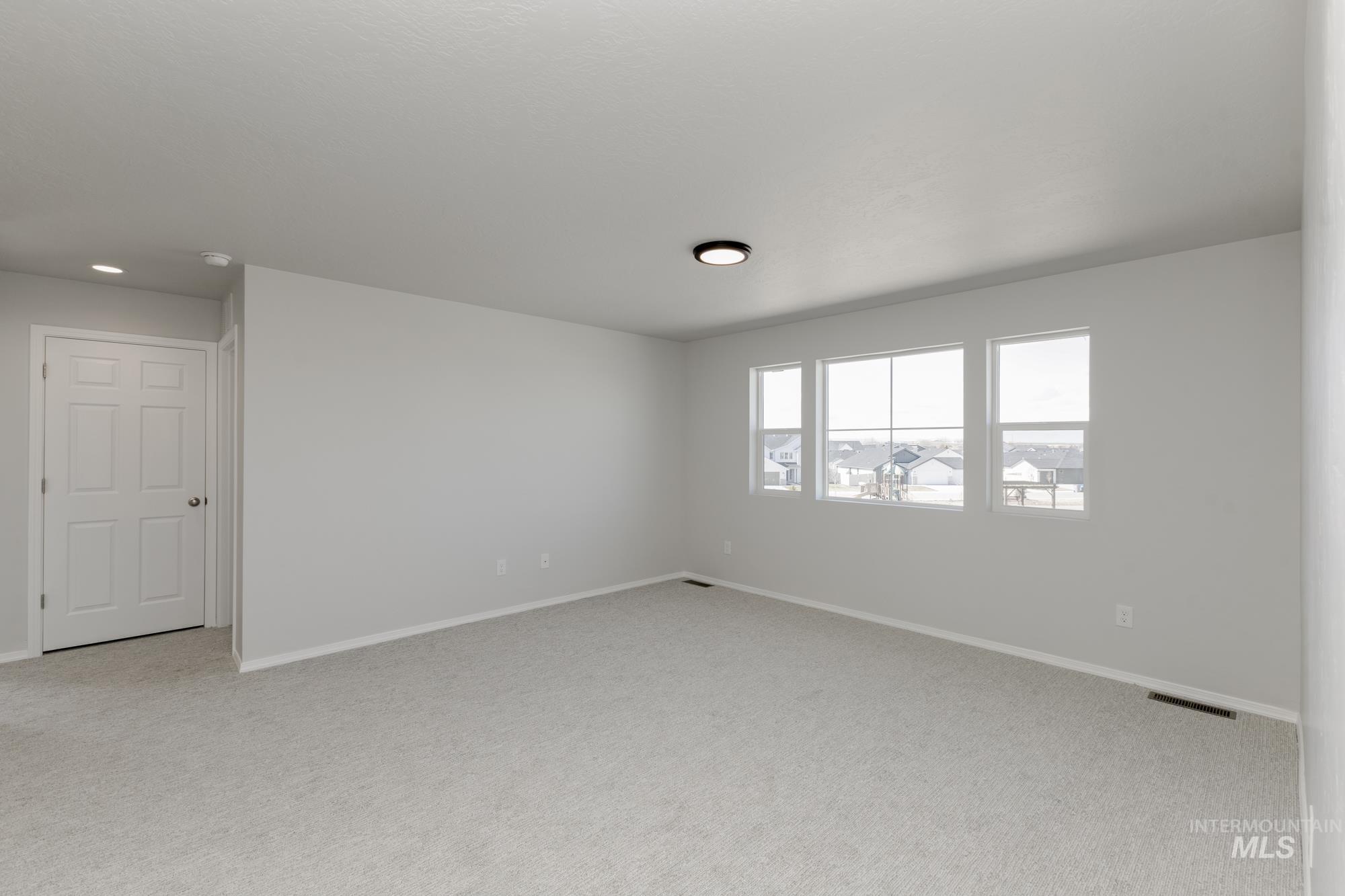 3270 South Maple Rnch Way Nampa, ID 83686 - Photo 19 of 31 Unfurnished room featuring baseboards and light colored carpet