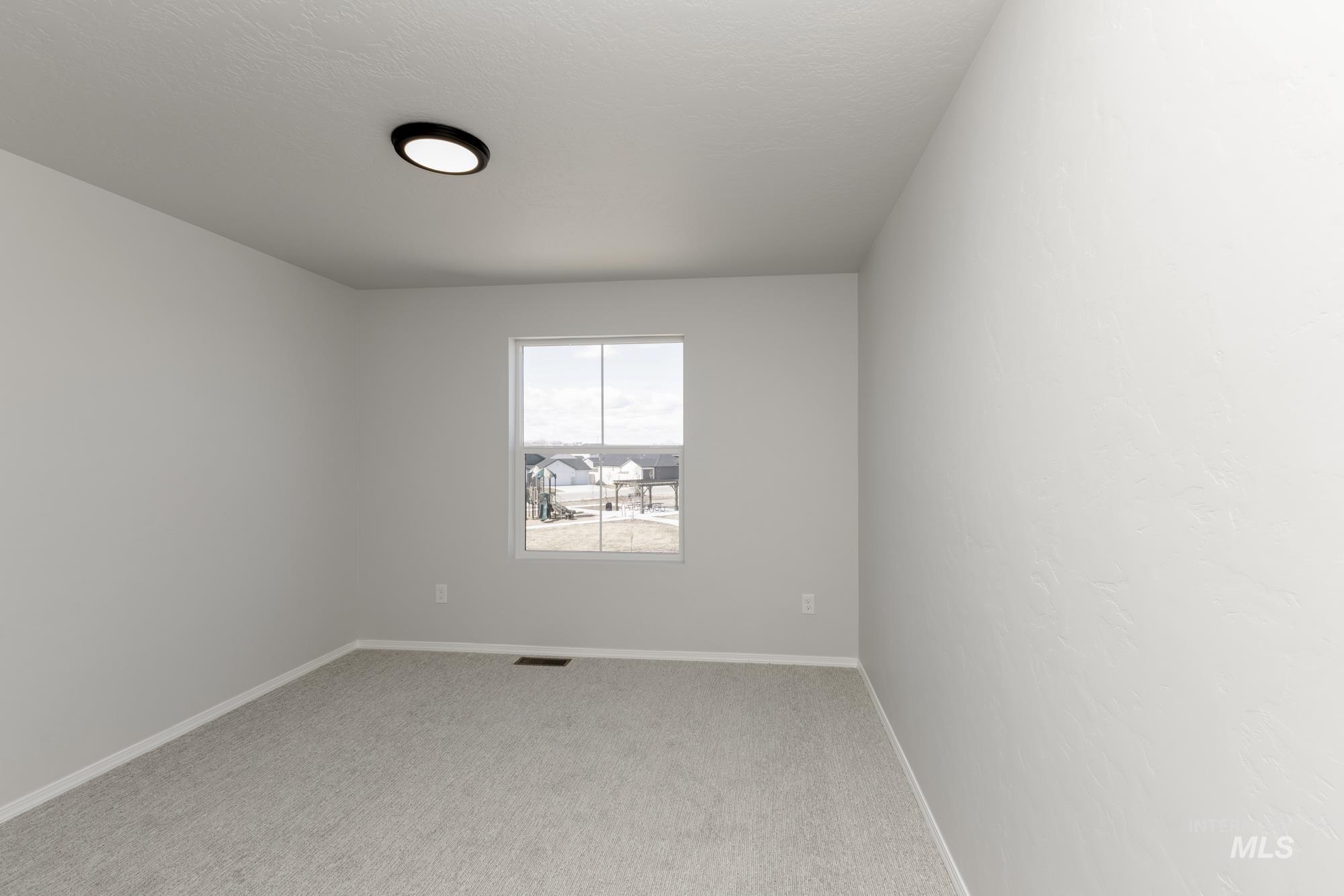 3270 South Maple Rnch Way Nampa, ID 83686 - Photo 20 of 31 Unfurnished room with light colored carpet and baseboards