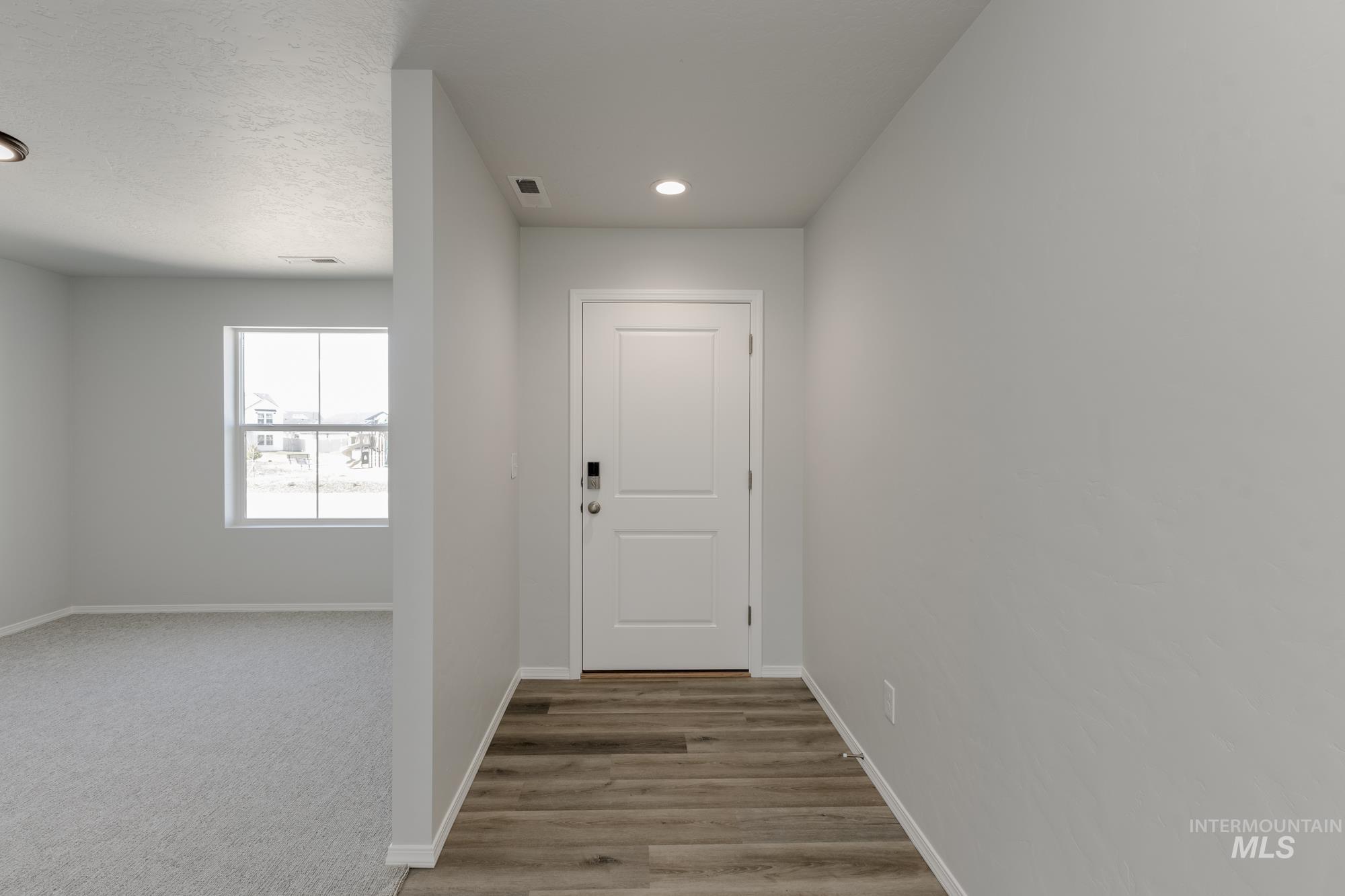 3270 South Maple Rnch Way Nampa, ID 83686 - Photo 2 of 31 Entryway featuring carpet flooring, recessed lighting, wood finished floors, and a textured ceiling