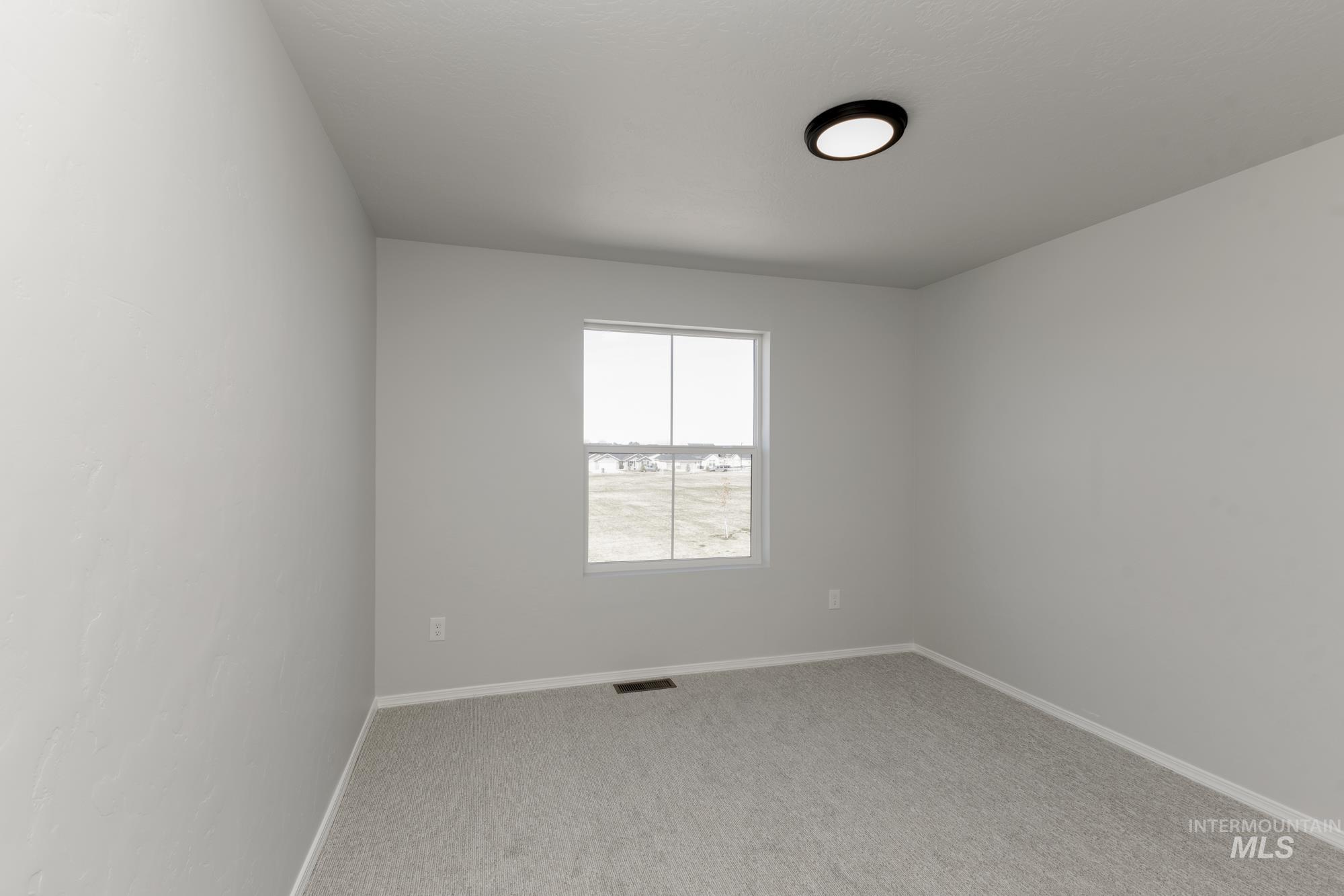 3270 South Maple Rnch Way Nampa, ID 83686 - Photo 22 of 31 Unfurnished room with baseboards and light carpet