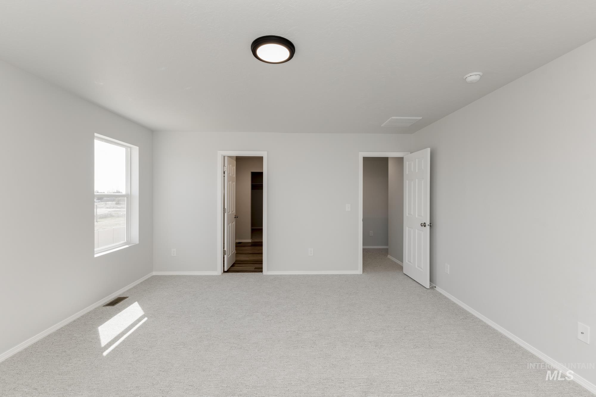 3270 South Maple Rnch Way Nampa, ID 83686 - Photo 28 of 31 Unfurnished bedroom with a walk in closet and light colored carpet