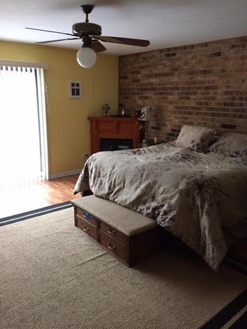 212 West Coventry Place Mount Prospect, IL 60056 - Photo 11 of 21 a bedroom with a bed and a chandelier