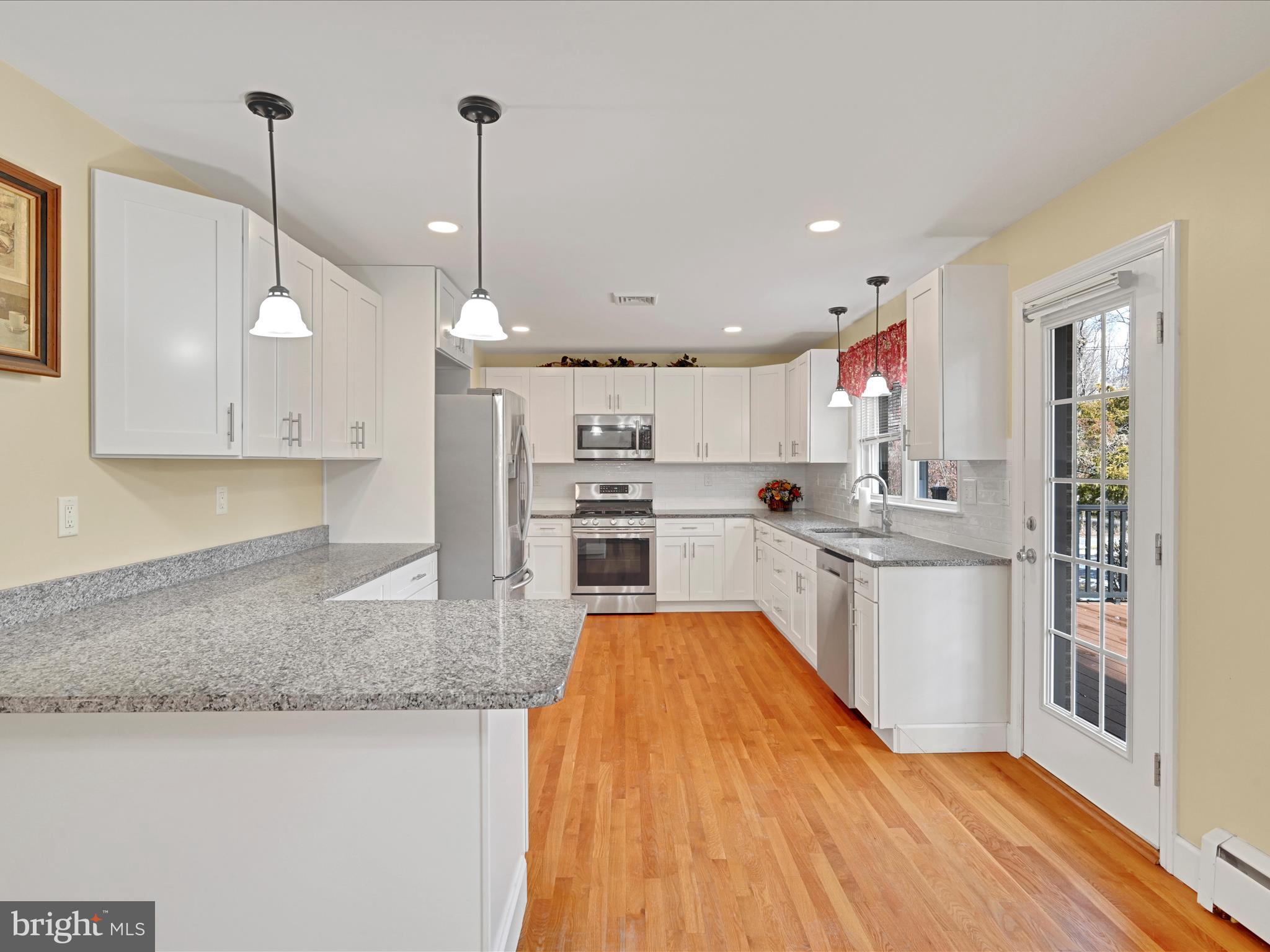 4500 Channing Road Wilmington, DE 19802 - Photo 11 of 35 a large kitchen with kitchen island a sink a counter space stainless steel appliances and cabinets
