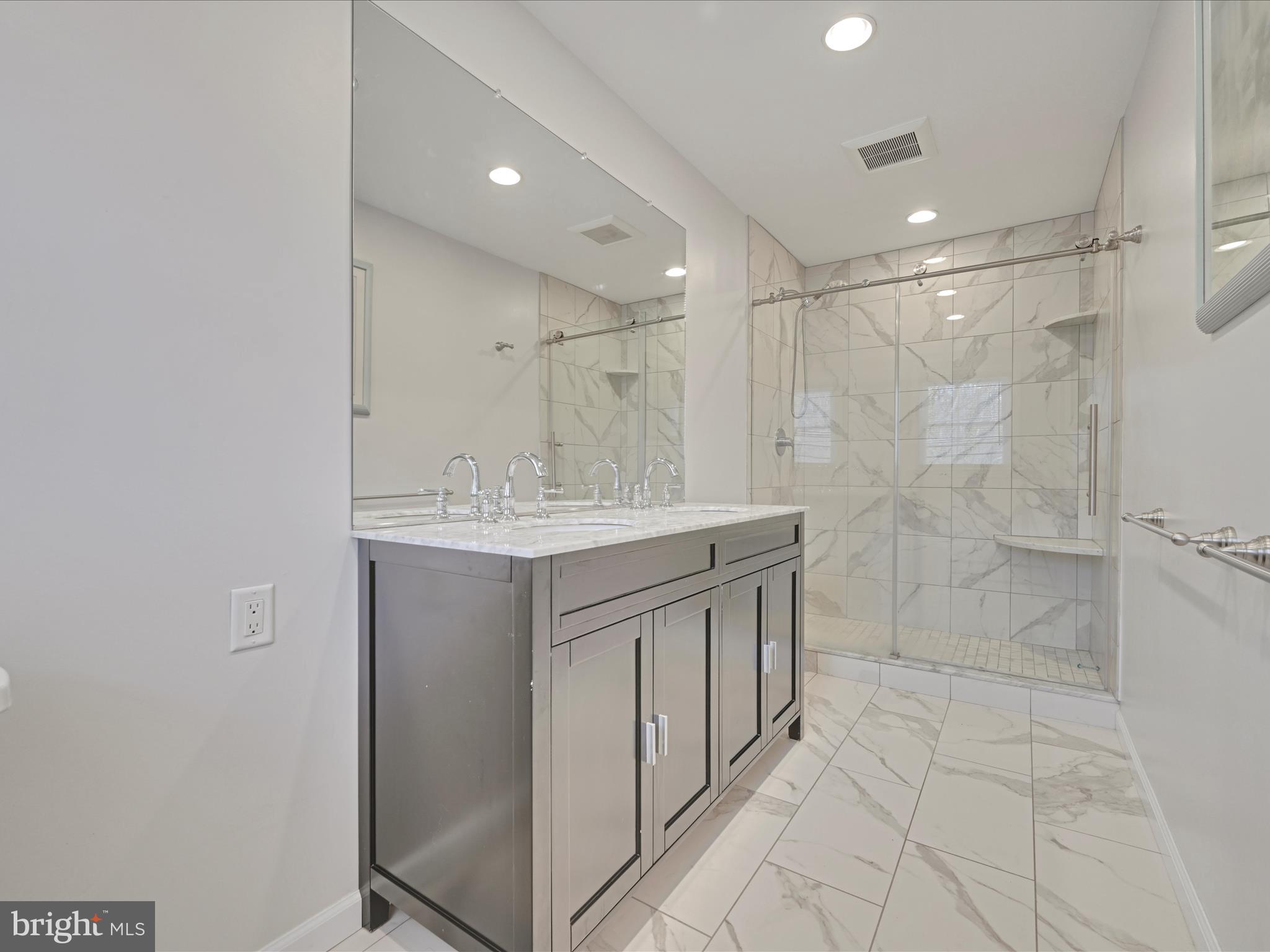 4500 Channing Road Wilmington, DE 19802 - Photo 17 of 35 a bathroom with a shower sink and mirror