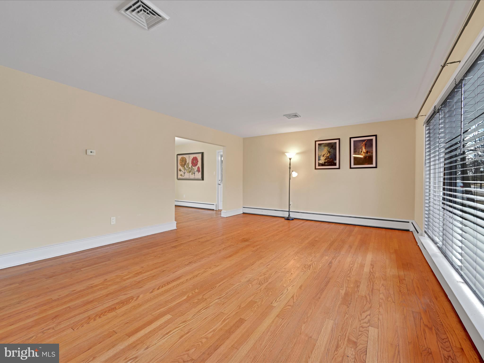 4500 Channing Road Wilmington, DE 19802 - Photo 5 of 35 an empty room with wooden floor and windows