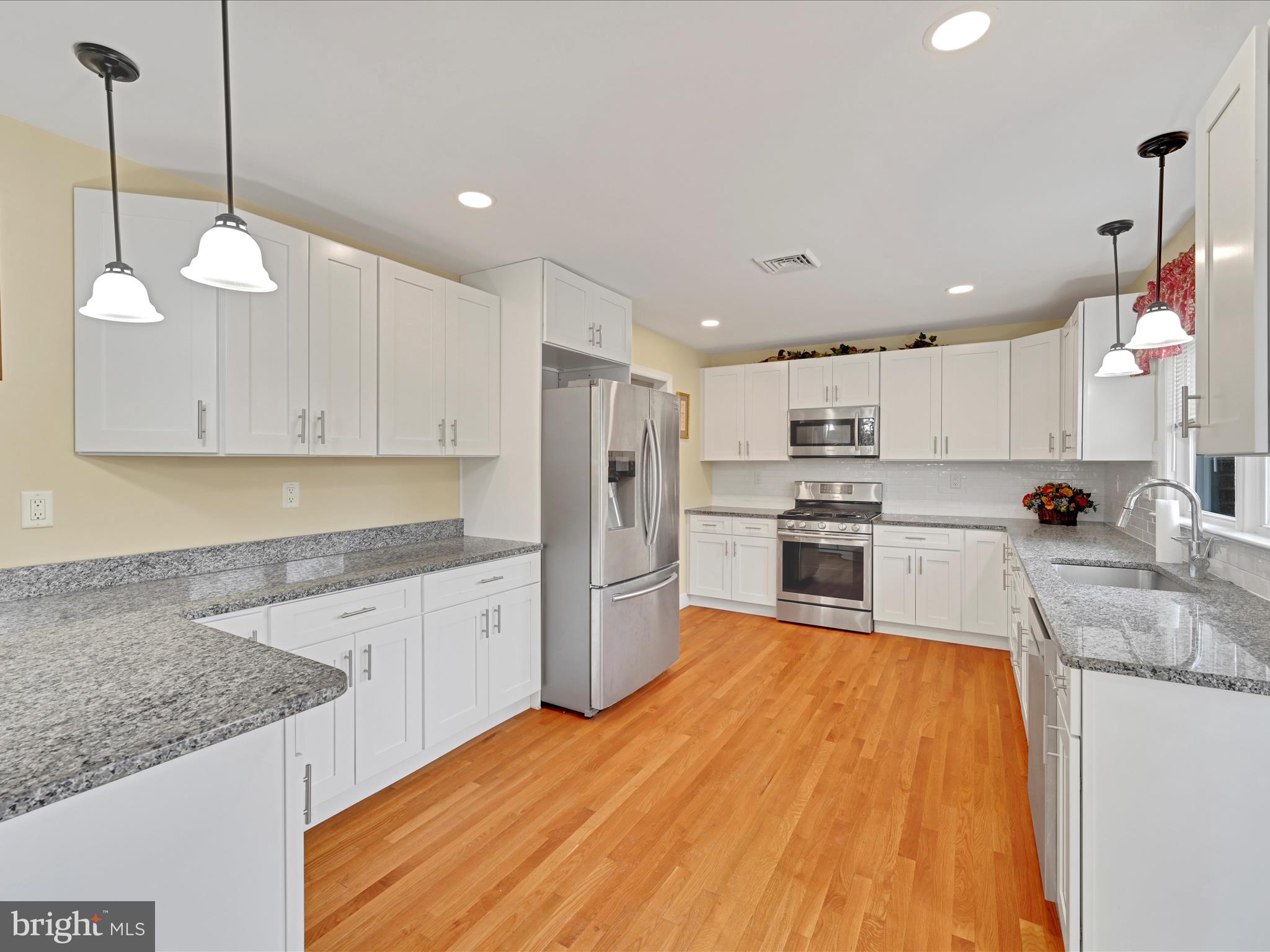 4500 Channing Road Wilmington, DE 19802 - Photo 9 of 35 a large kitchen with stainless steel appliances granite countertop a sink a stove and a refrigerator