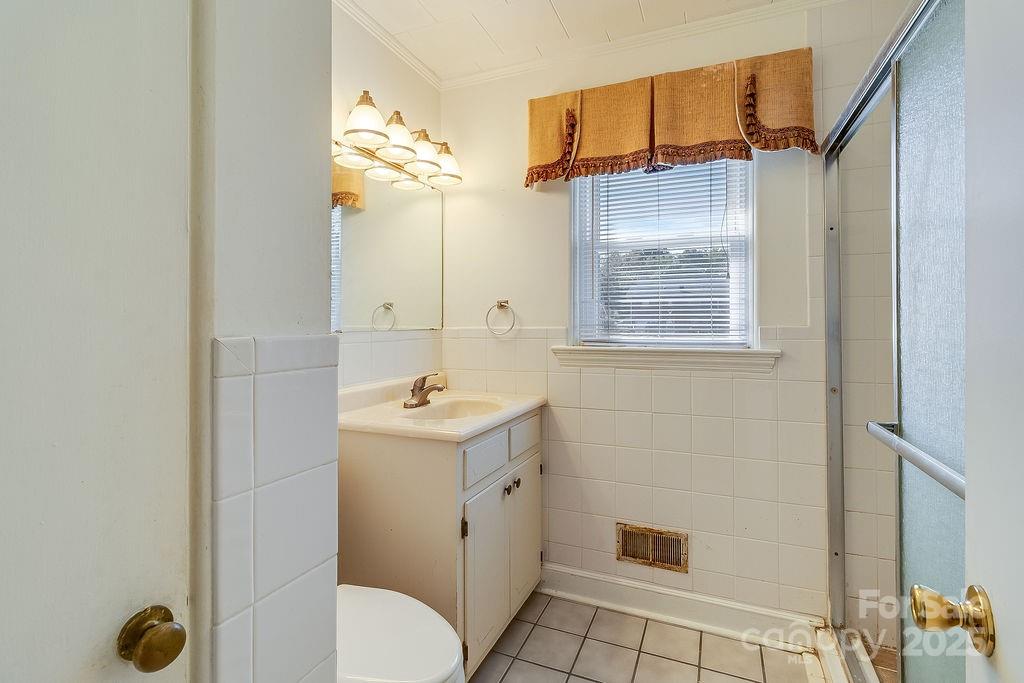209 Park Street Morganton, NC 28655 - Photo 31 of 35 a bathroom with a sink a toilet and shower