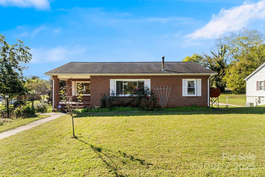 209 Park Street Morganton, NC 28655 - Photo 4 of 35 a front view of a house with garden