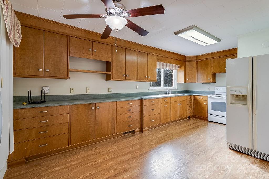 209 Park Street Morganton, NC 28655 - Photo 7 of 35 a kitchen with granite countertop stainless steel appliances and wooden cabinets