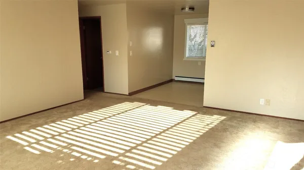 a view of a bedroom with wooden floor and bathroom