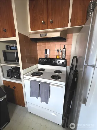 a kitchen with a sink a window and cabinets