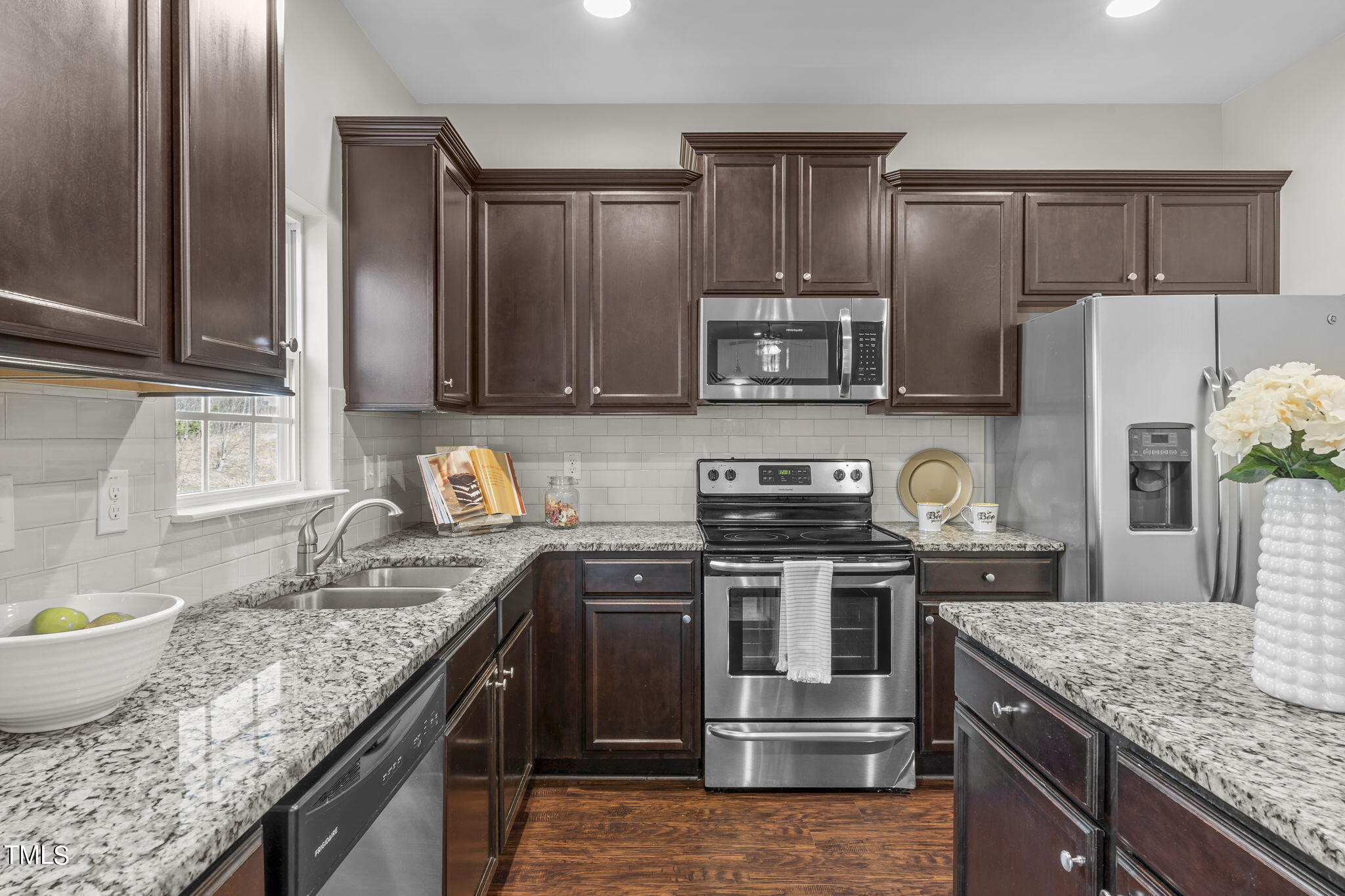 3652 Tule Spring Street Raleigh, NC 27610 - Photo 21 of 51 a kitchen with granite countertop a sink stove and refrigerator