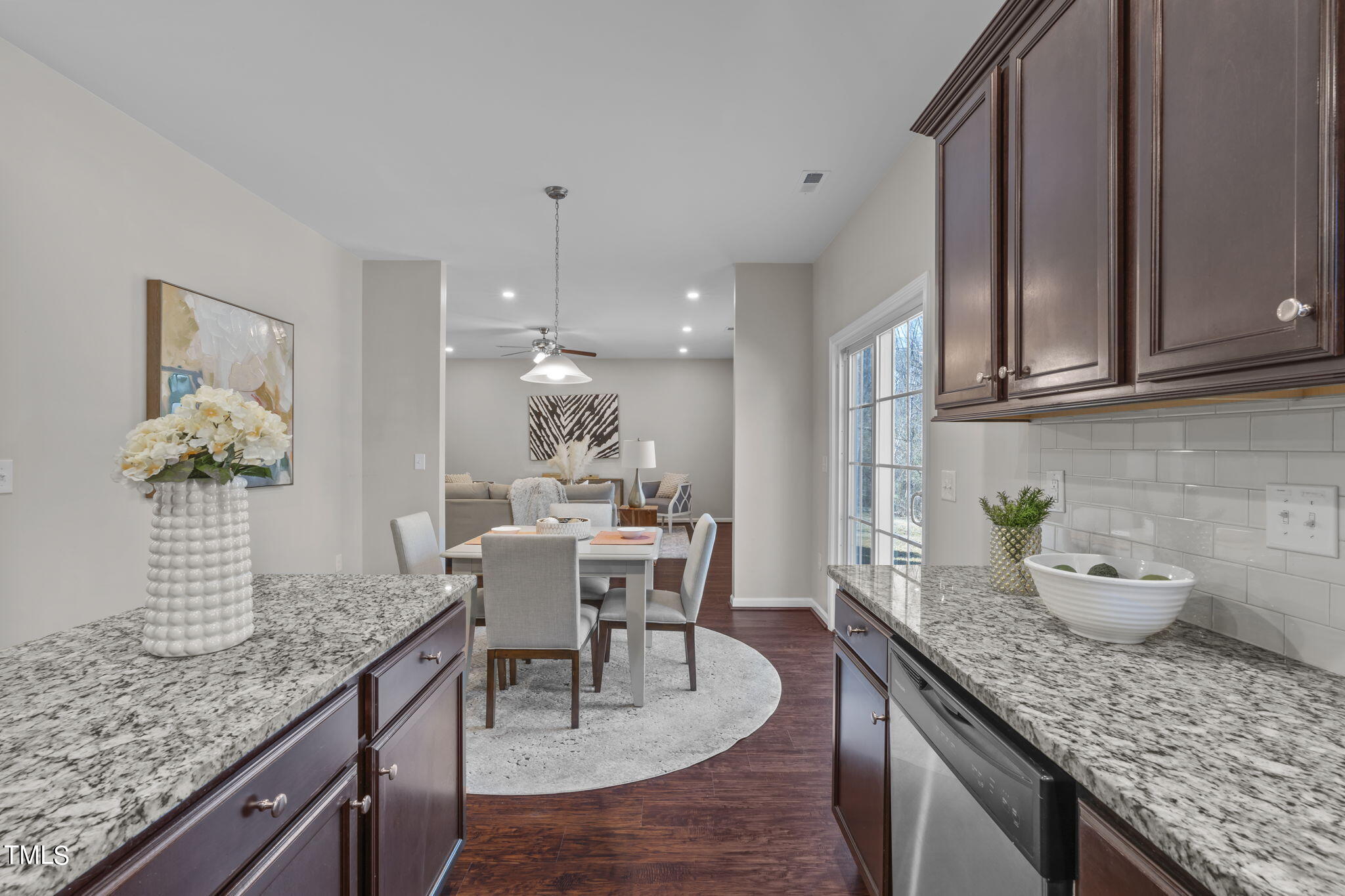 3652 Tule Spring Street Raleigh, NC 27610 - Photo 22 of 51 a dining room with granite countertop kitchen island stainless steel appliances a sink table and chairs