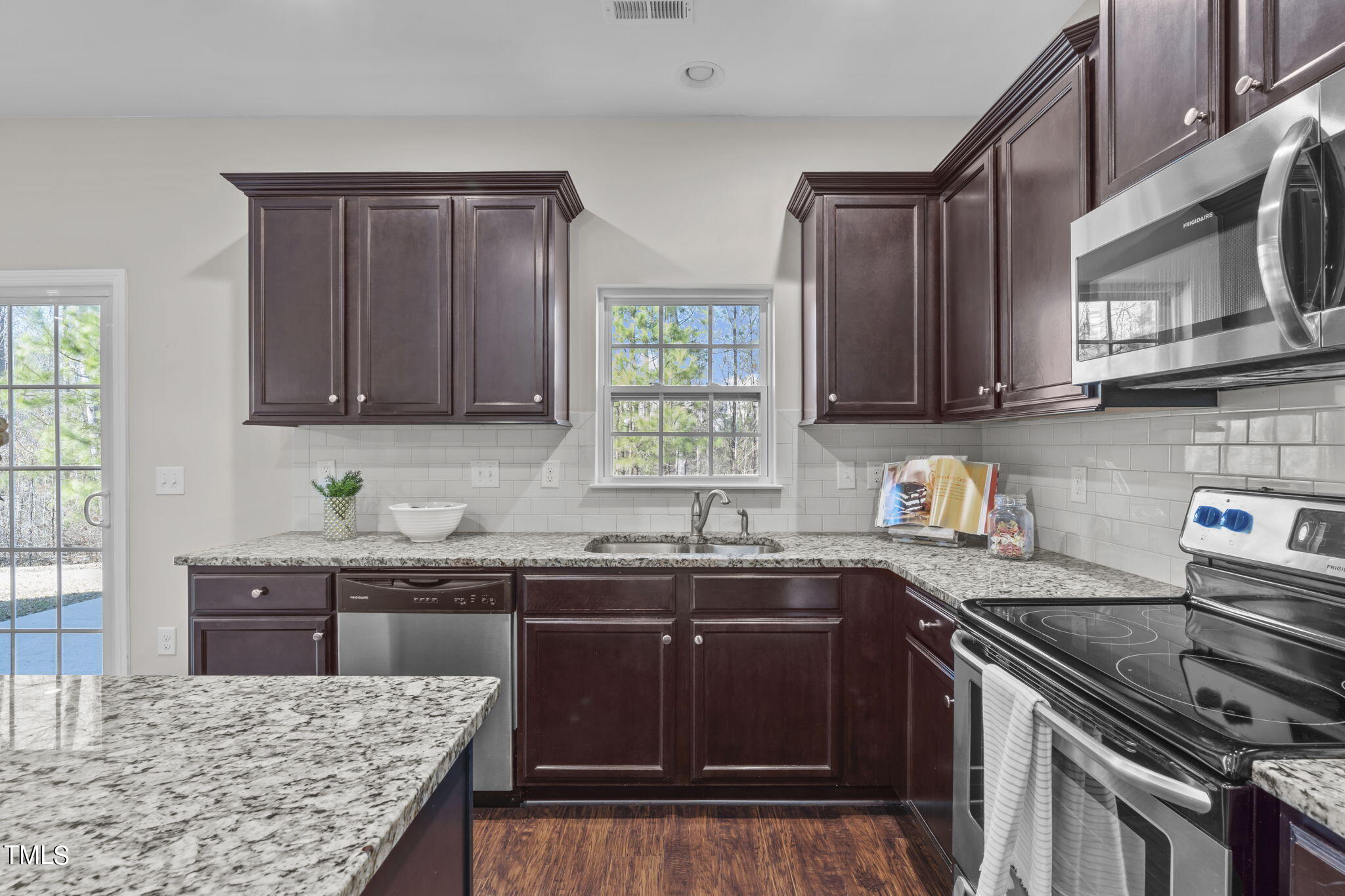 3652 Tule Spring Street Raleigh, NC 27610 - Photo 23 of 51 a kitchen with stainless steel appliances granite countertop a stove a sink dishwasher and cabinets with wooden floor