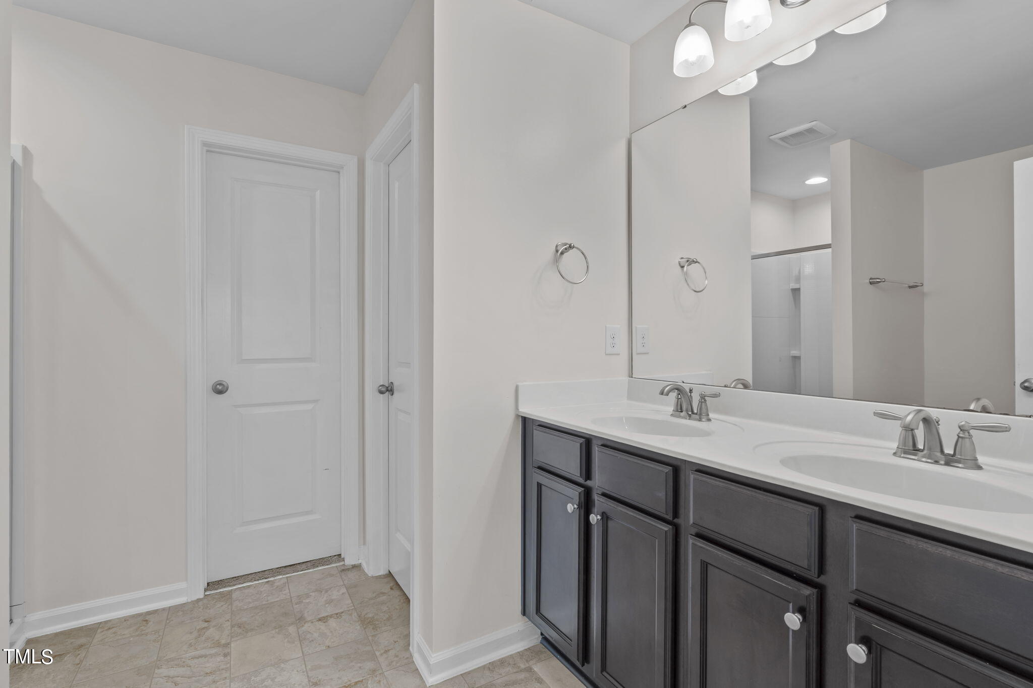 3652 Tule Spring Street Raleigh, NC 27610 - Photo 38 of 51 a bathroom with a double vanity sink and mirror