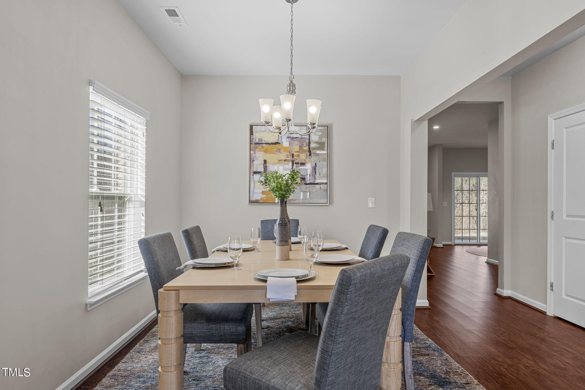 3652 Tule Spring Street Raleigh, NC 27610 - Photo 9 of 51 a view of a dining room with furniture wooden floor and chandelier