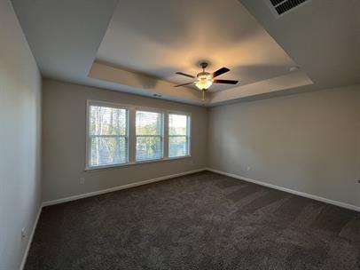 2267 Graywell Lane Duluth, GA 30096 - Photo 12 of 26 an empty room with a chandelier fan and windows