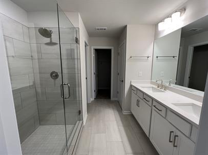 2267 Graywell Lane Duluth, GA 30096 - Photo 14 of 26 a bathroom with a double vanity sink a toilet and shower