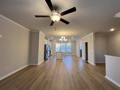 2267 Graywell Lane Duluth, GA 30096 - Photo 4 of 26 a view of an empty room with wooden floor and a ceiling fan