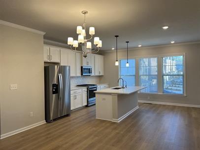 2267 Graywell Lane Duluth, GA 30096 - Photo 6 of 26 a view of a kitchen with a sink wooden floor and a refrigerator