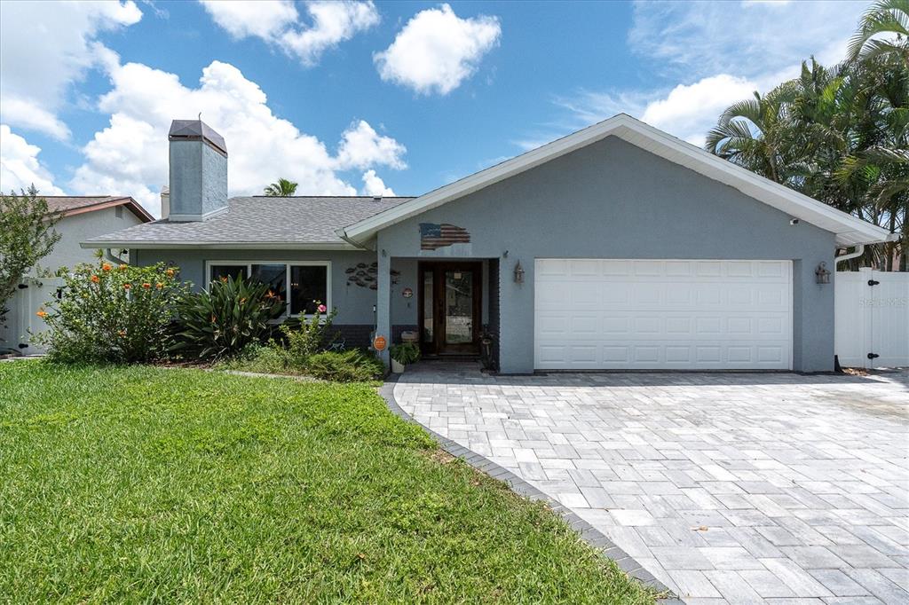 12107 72nd Way Largo, FL 33773 - Photo 1 of 40 a front view of a house with a yard and garage